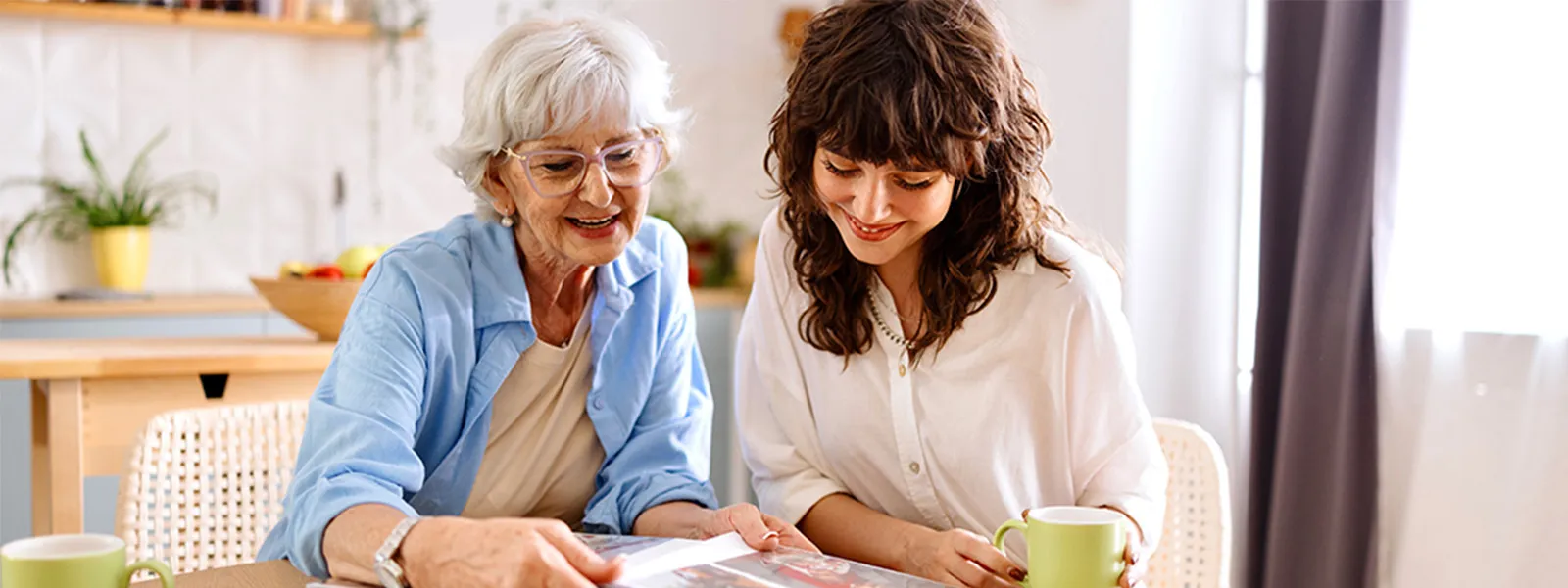 mother and daughter looking at photo album