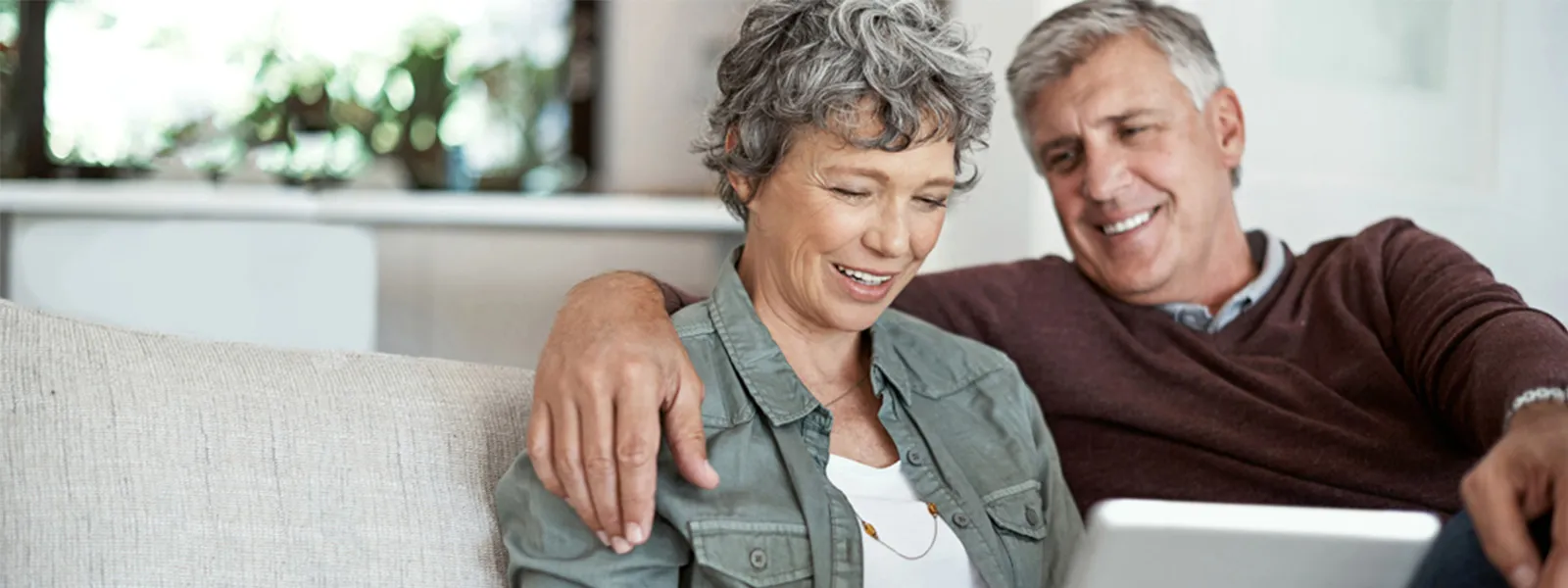 couple laughing while on computer